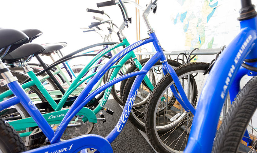 close up of blue Electra beach cruiser bicycles in bike rack