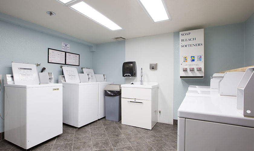 white washer and dryers in laundry room